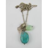 A silver and turquoise bead pendant having butterfly upon, on silver chain.