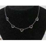 A silver five heart necklace, stamped 925, adjustable length 43 - 45cm.