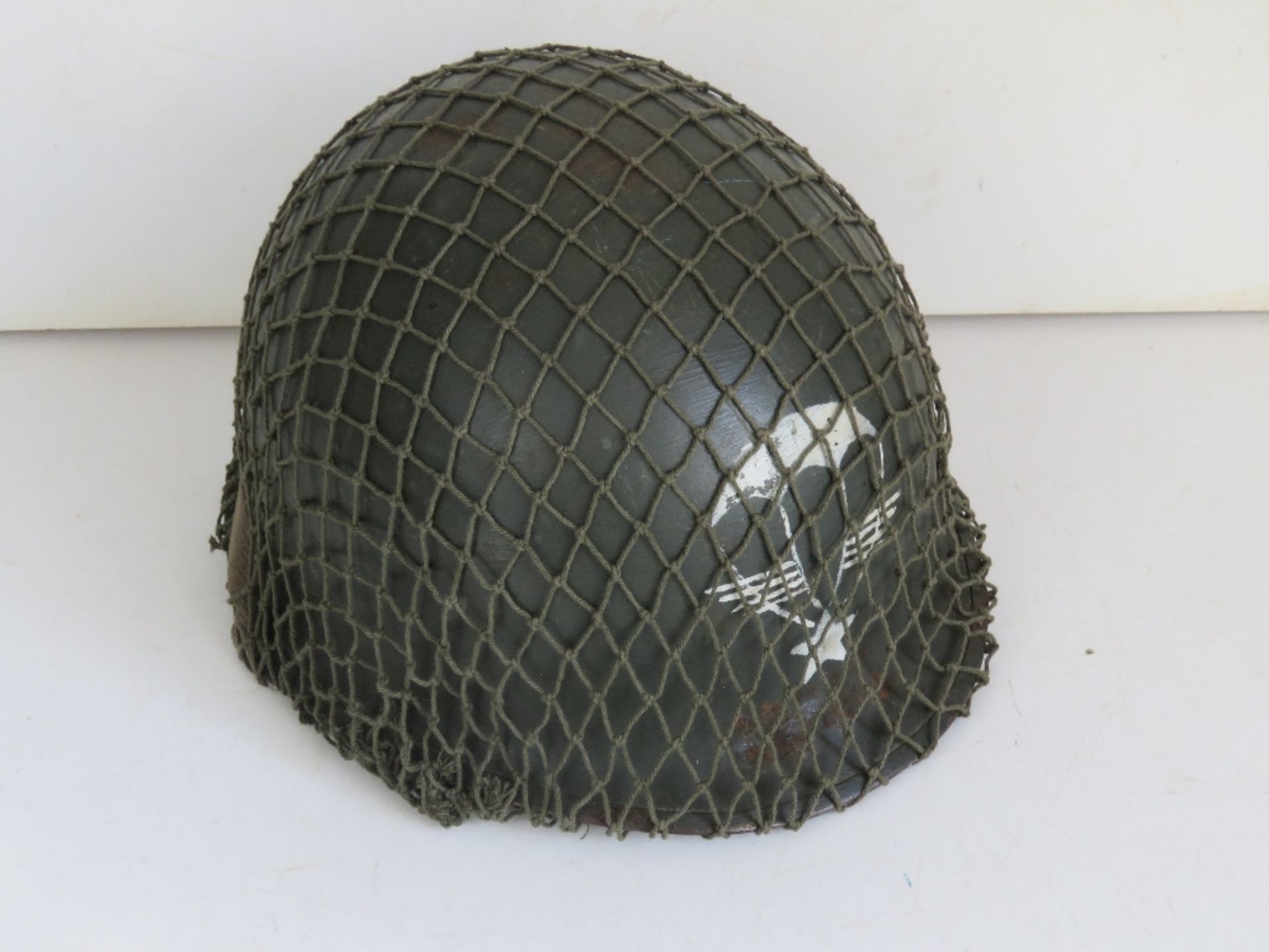 A French M1 Para helmet with liner and chin strap.