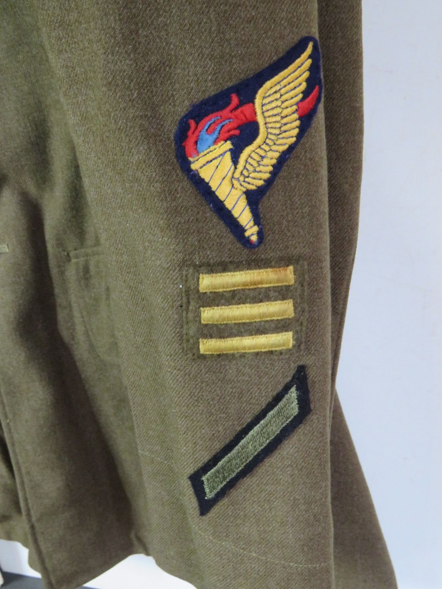 A WWII US Airborne tunic, having all buttons and numerous patches and badges. - Image 4 of 8