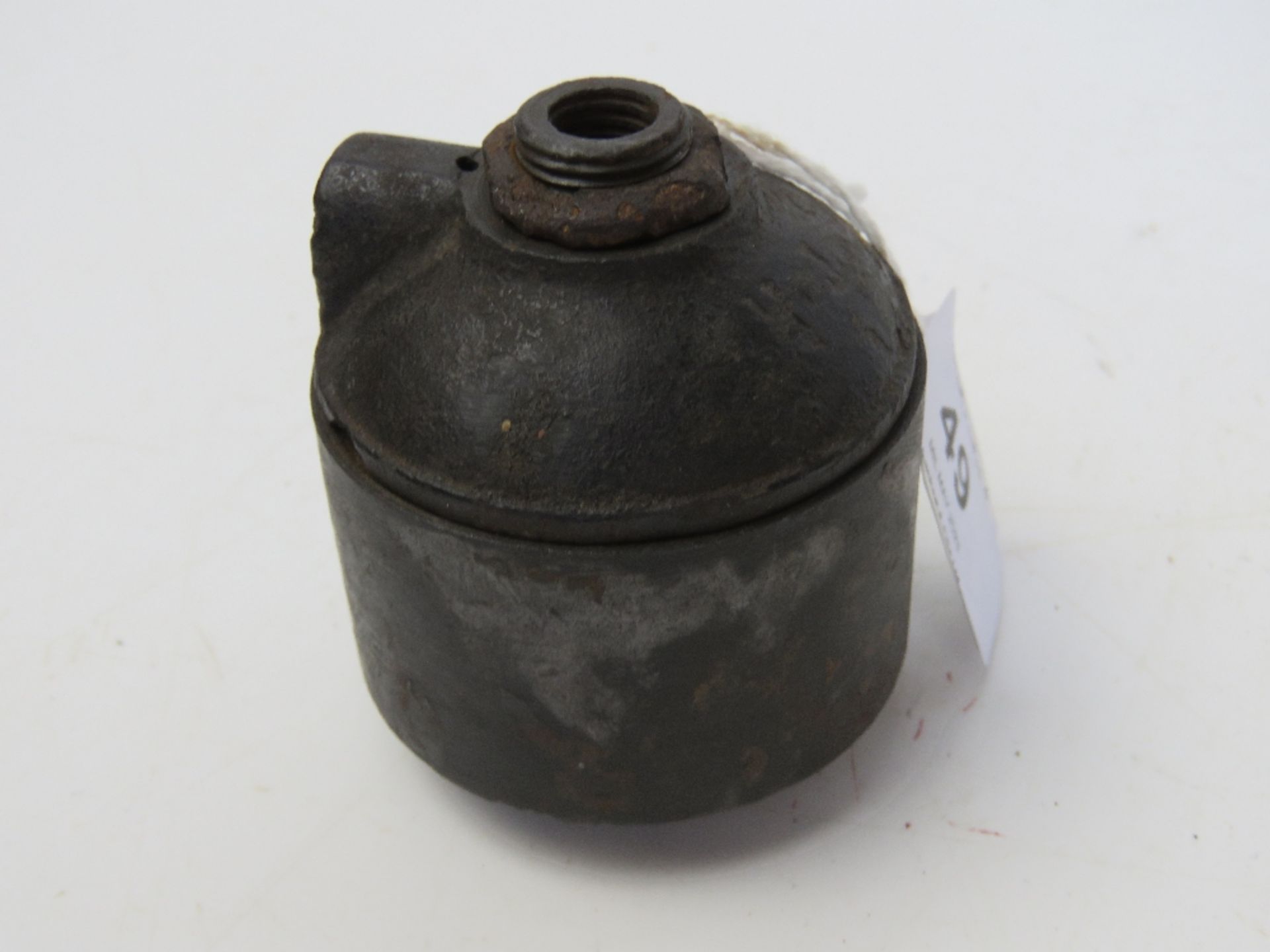 An inert WWI Ink Pot German grenade, bearing T.R markings on top, comes apart.