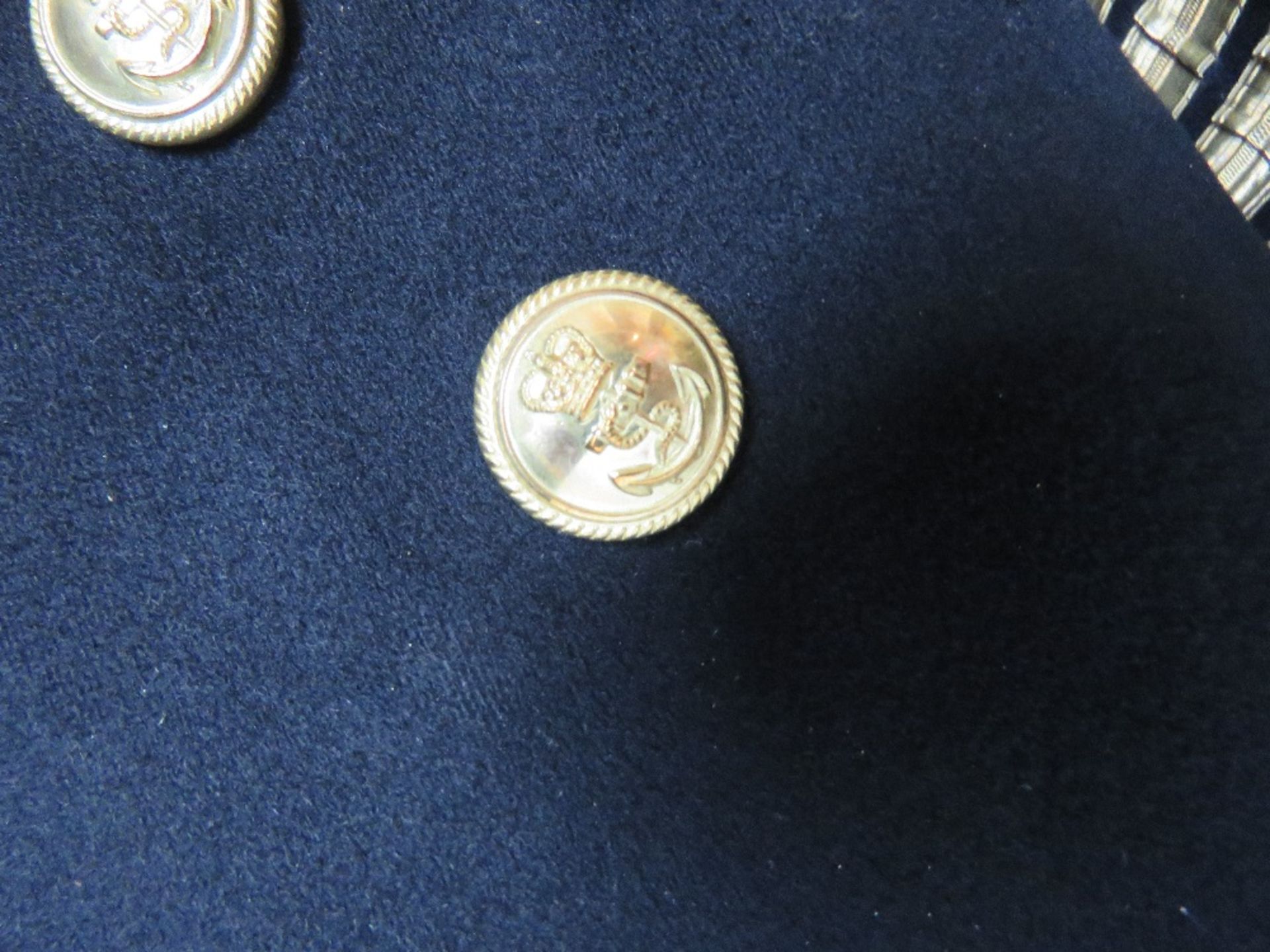 A British Naval jacket having brass buttons and four gilt stripes to cuff. - Image 2 of 2