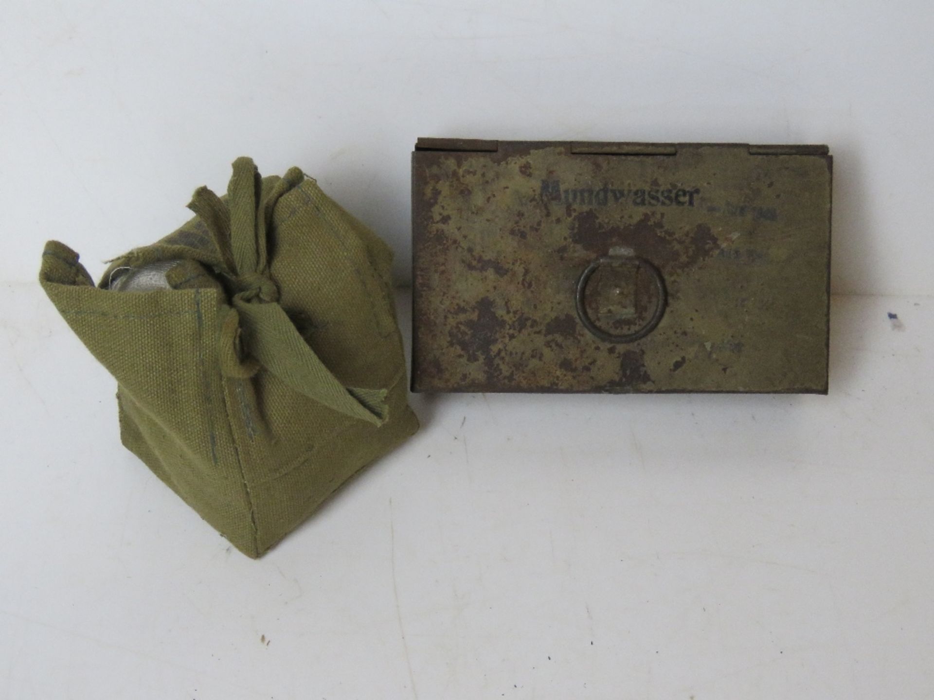 A WWII German Wehrmacht First Aid bandage in pouch together with a WWII German Military mouth wash