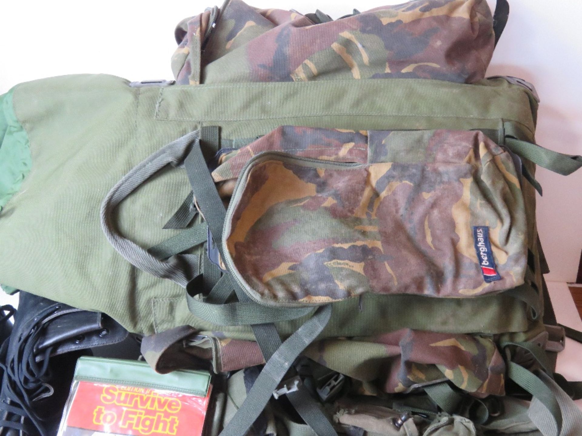 A Berghaus camouflage military rucksack containing a large quantity of kit inc black leather boots, - Image 3 of 3