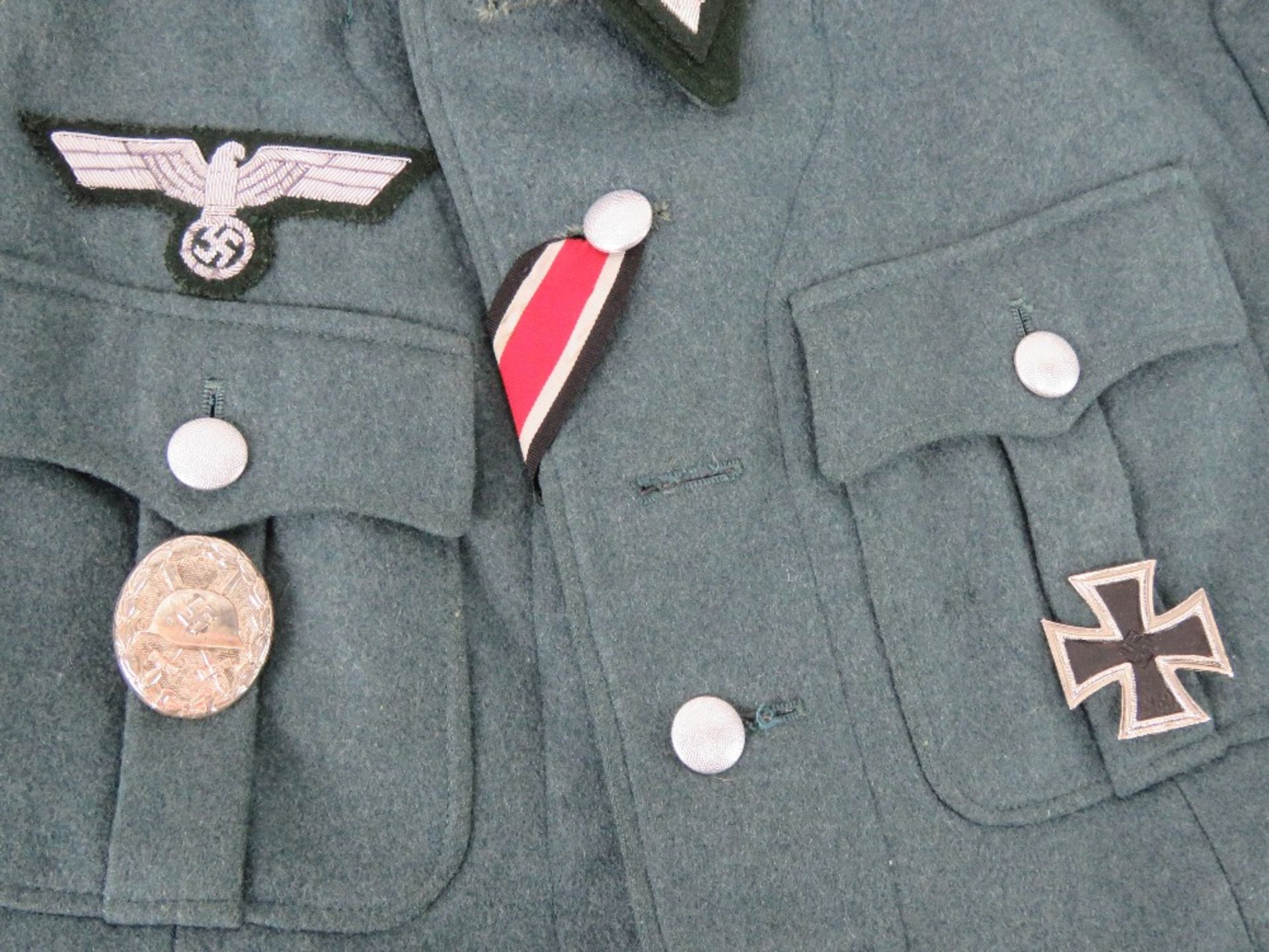 A reproduction German Combat Jacket with Insignia, and breeches. - Image 3 of 6