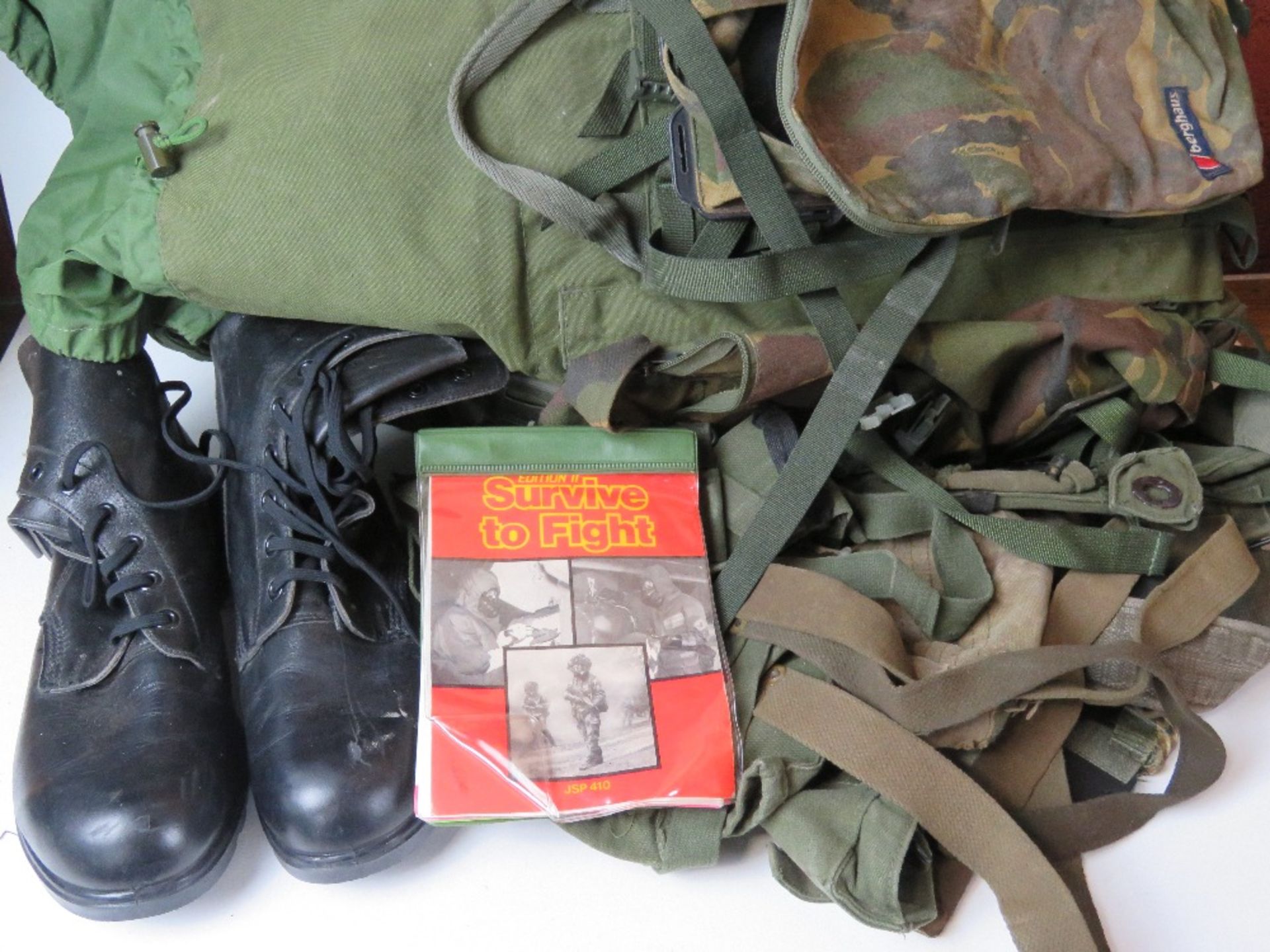 A Berghaus camouflage military rucksack containing a large quantity of kit inc black leather boots, - Image 2 of 3