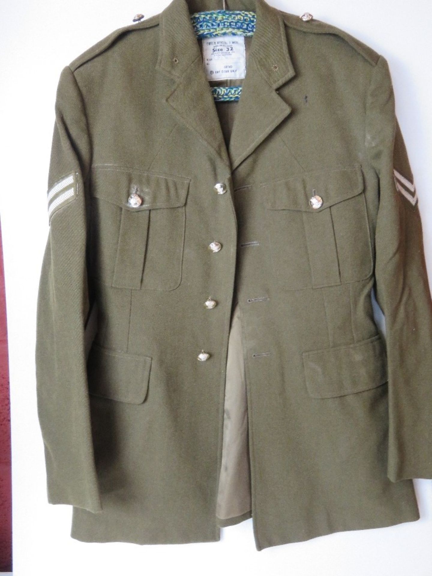 A British Army No 2 dress tunic, size 32, having patches and buttons upon.