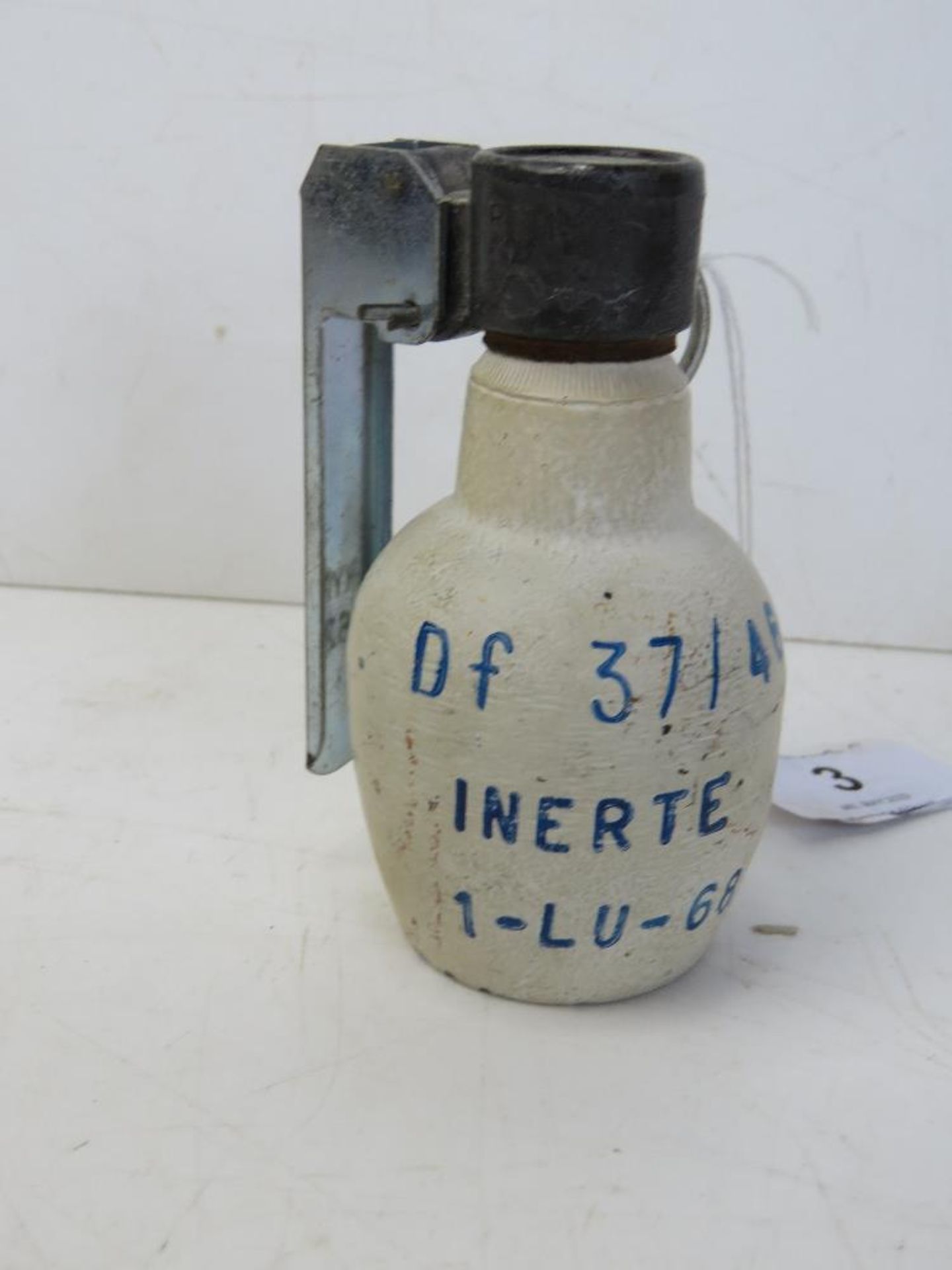 An inert French 1968 defensive grenade, dated 1968, with fuse, spoon and pin,