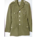 A British Army No 2 dress tunic and trousers, having epaulette badges upon,