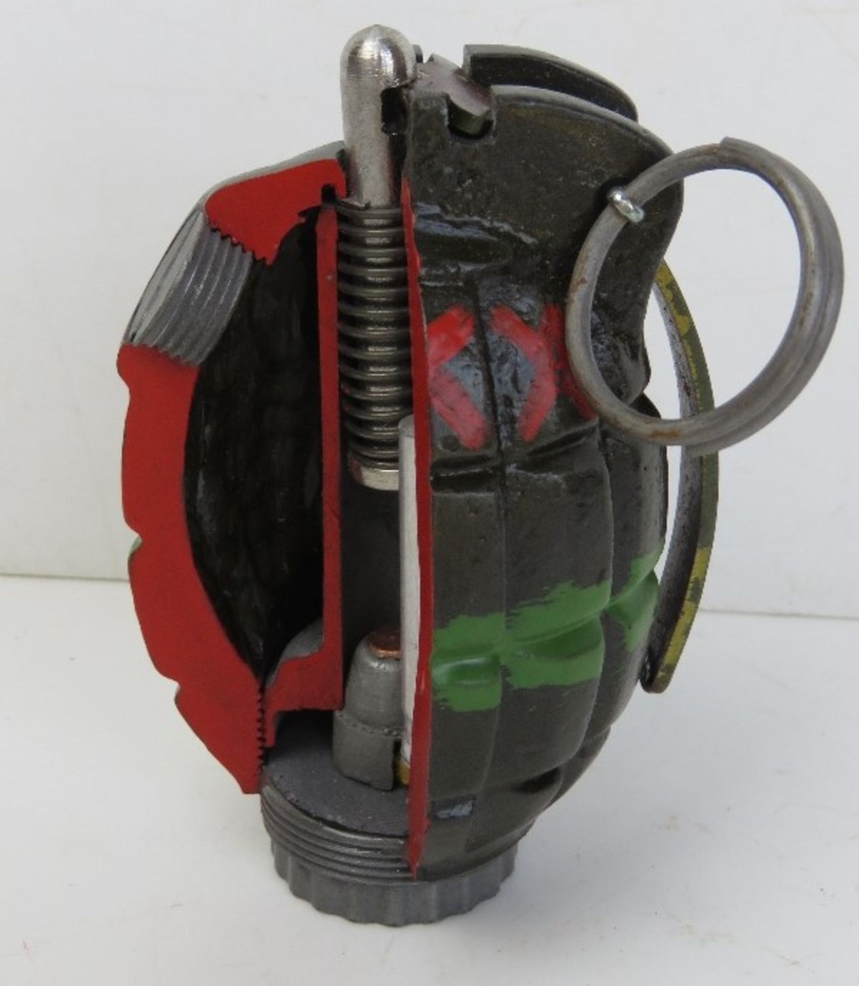 An inert resin No.36 Mills cutaway grenade.