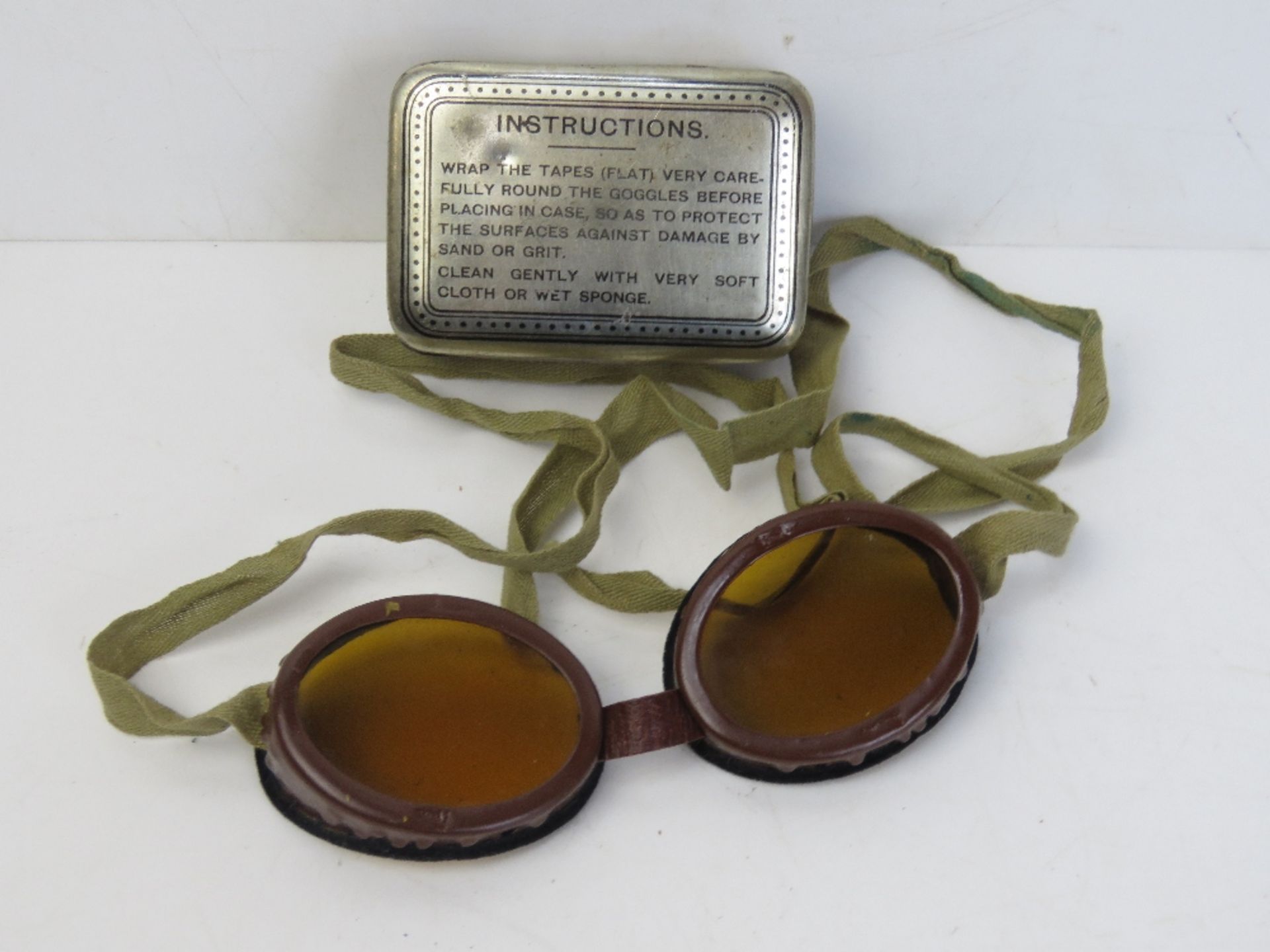 A pair of SOE Mk 1 Jump goggles with strap in original tin, with cleaning instructions.