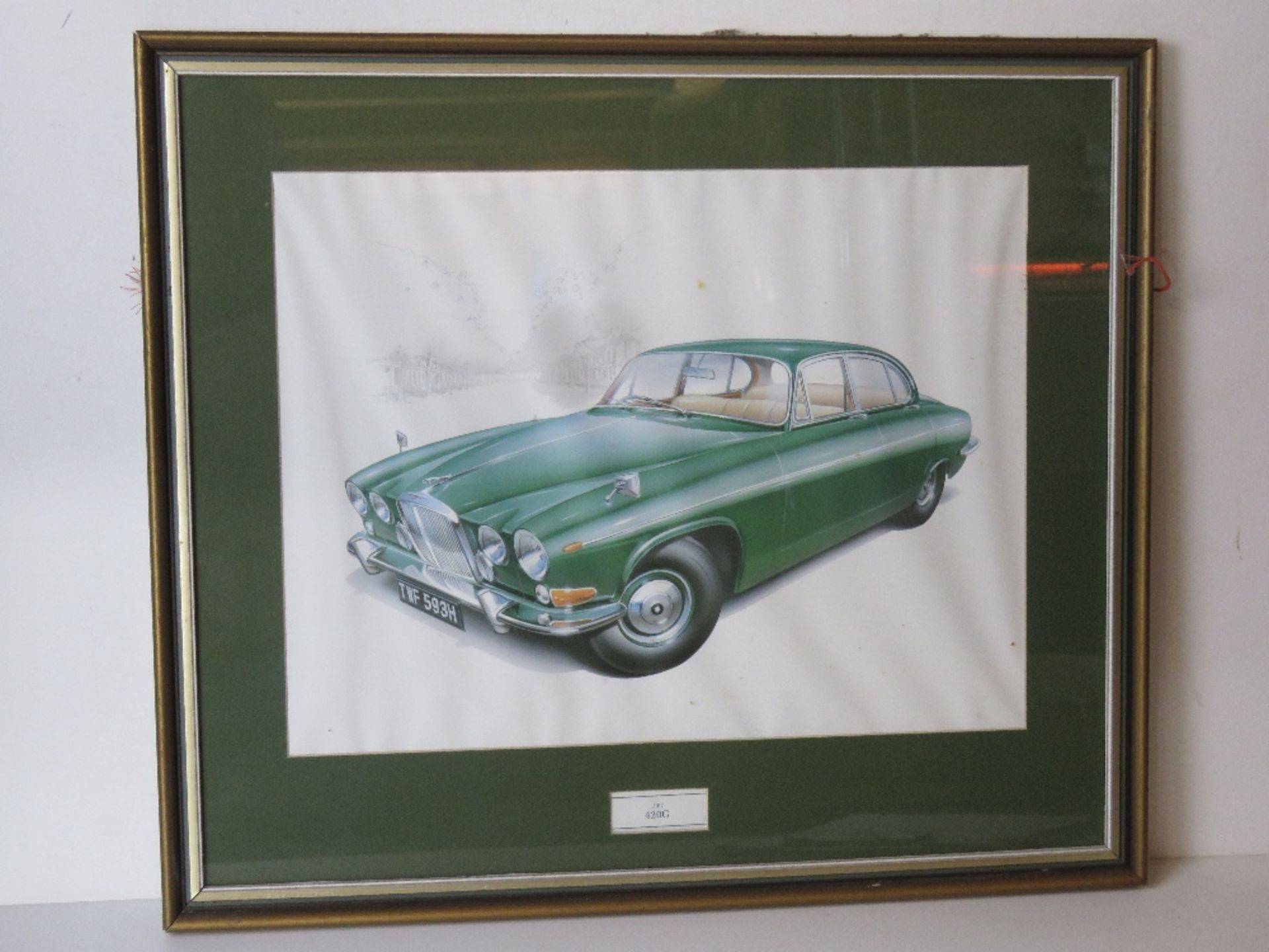 A framed and mounted print of a Jaguar 4