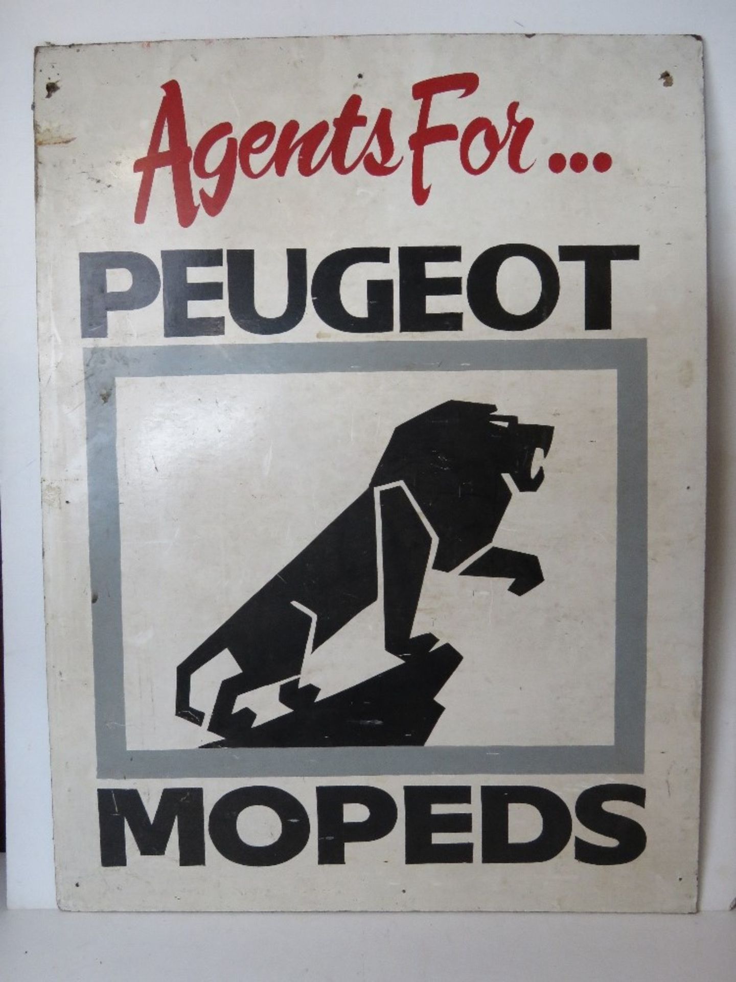 A painted advertising board 'Agents for