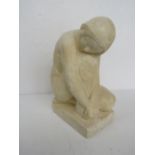 A plaster sculpture of a nude kneeling female, 28cm high.