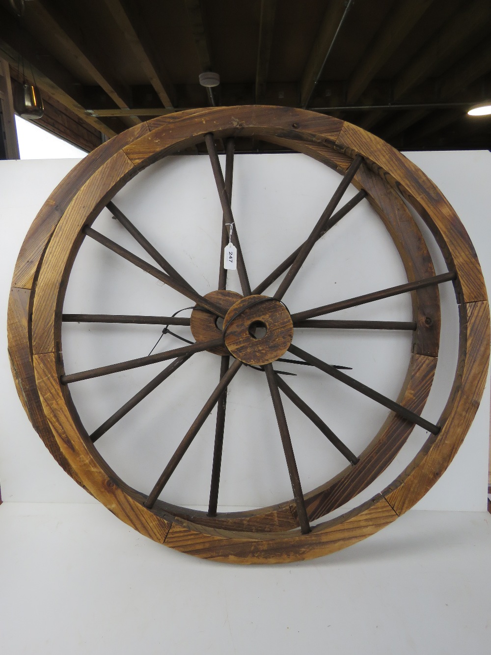 A pair of contemporary “Wagon Wheels” each approx. 80cm diameter.