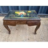 A coffee table having floral still life painting upon, central drawers with hidden drawers flanking.