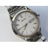 A stainless steel Seiko wrist watch having white dial with day and date apertures,