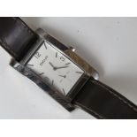 A ladies DKNY wrist watch having square shaped stainless steel head numbered 340001 on brown