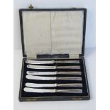 A set of six hallmarked silver handled butter knives, one handle loose, within fitted case.