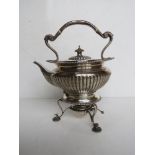 A delightful hallmarked silver teapot complete with stand and spirit burner,