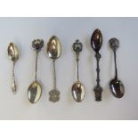 A sterling silver New York themed souvenir spoon together with two HM silver spoons and an EPNS