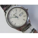 A stainless steel Seiko wrist watch having white dial with day and date apertures,
