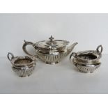 A hallmarked silver tea service comprising teapot, milk and sugar bowl,