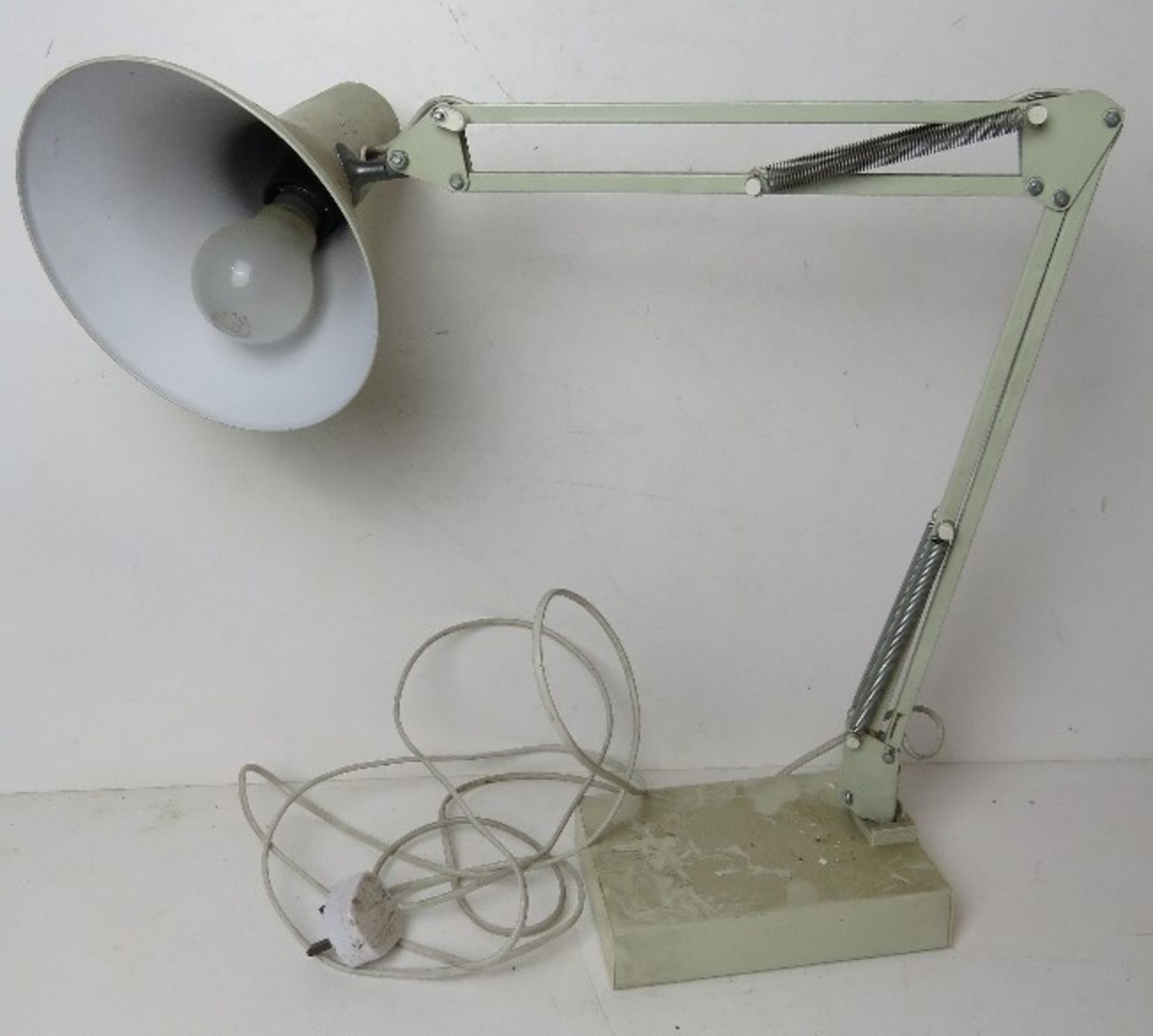A white painted metal angle poise style table lamp.