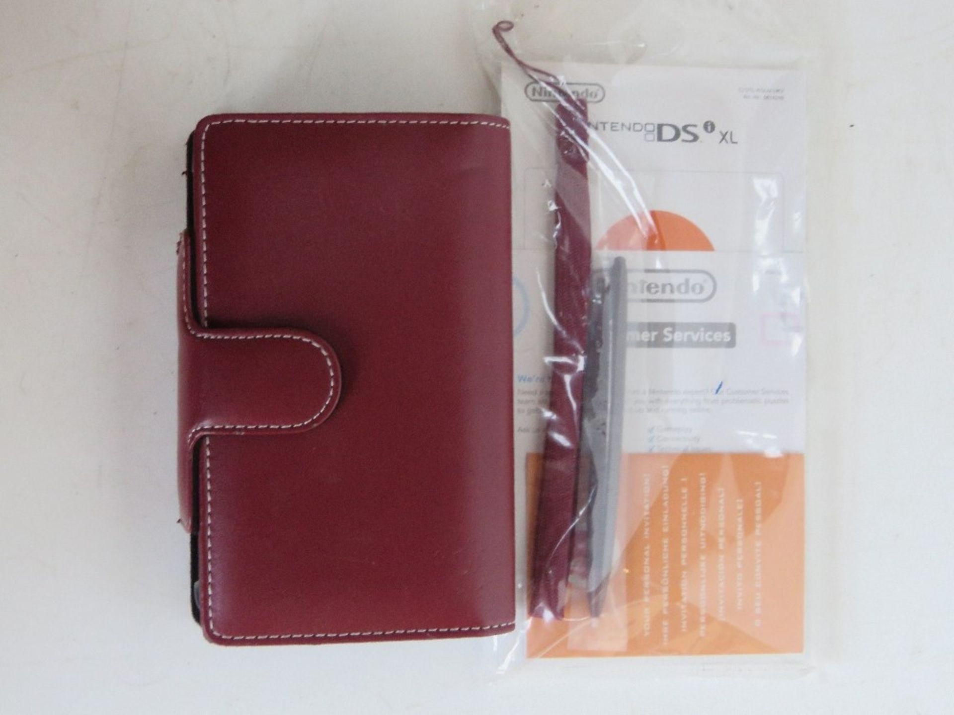 A Nintendo DS XL in burgundy with case, instructions and stylus. - Image 2 of 2