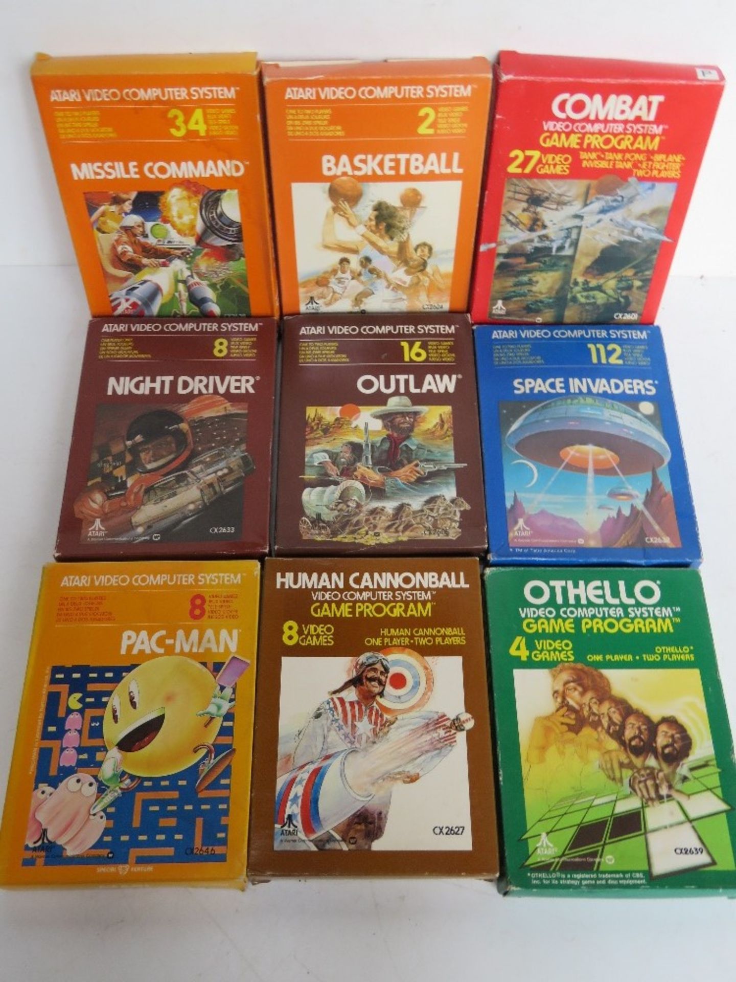Nine vintage boxed Atari video computer games inc PacMan, Space Invadors, Outlaw, etc.