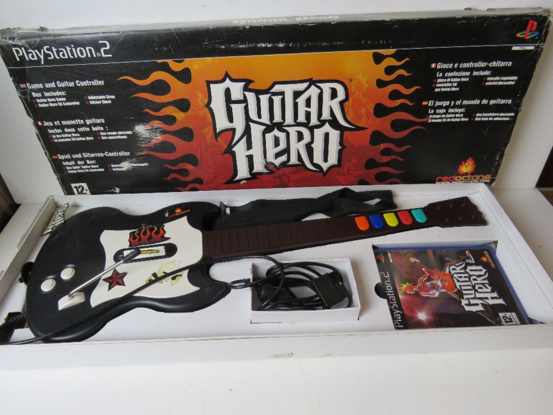 A Playstation 2 Guitar Hero with game in box.
