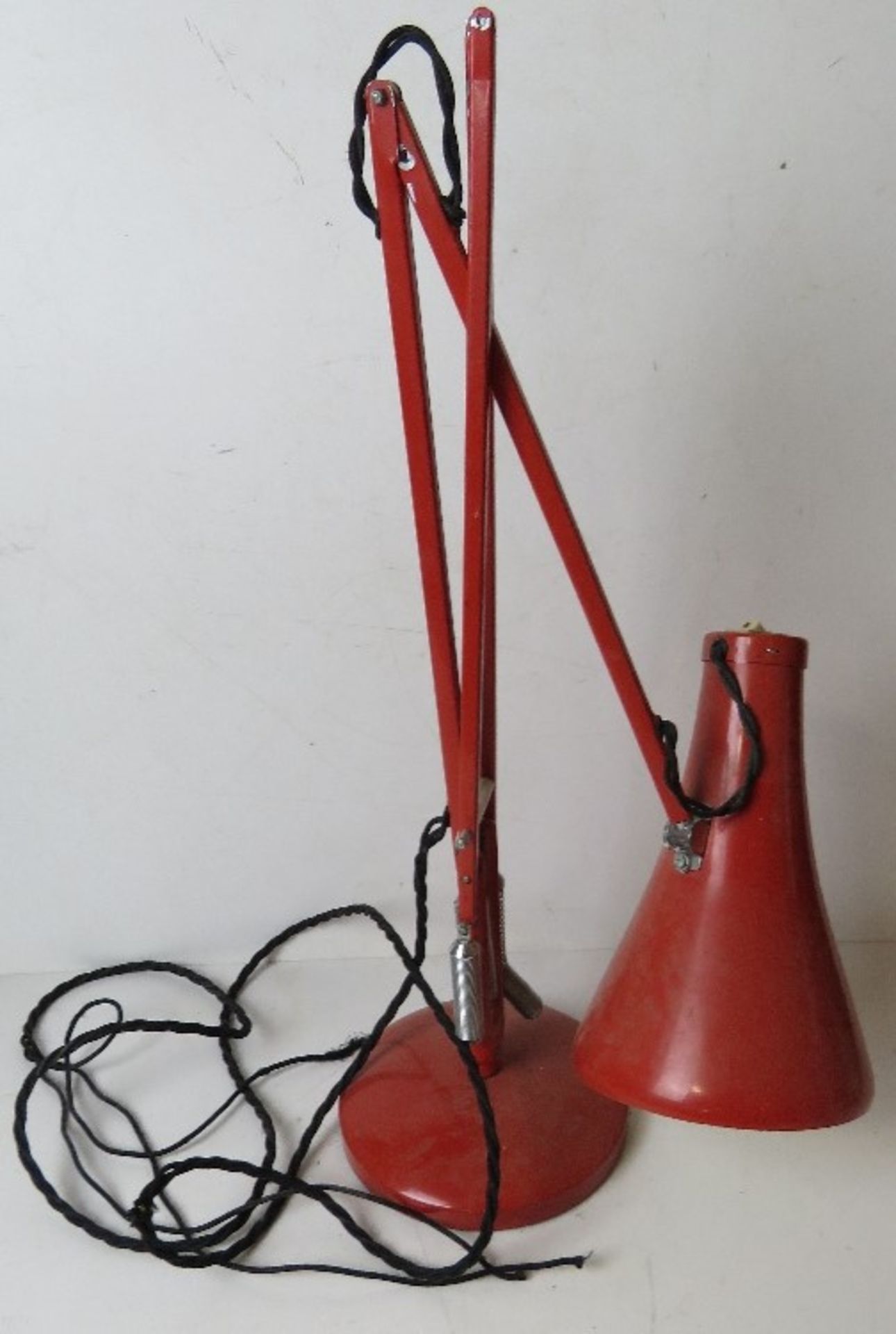 A vintage red metal angle poise lamp, slightly a/f.