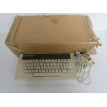 An Acorn Electron computer keyboard in original packaging.