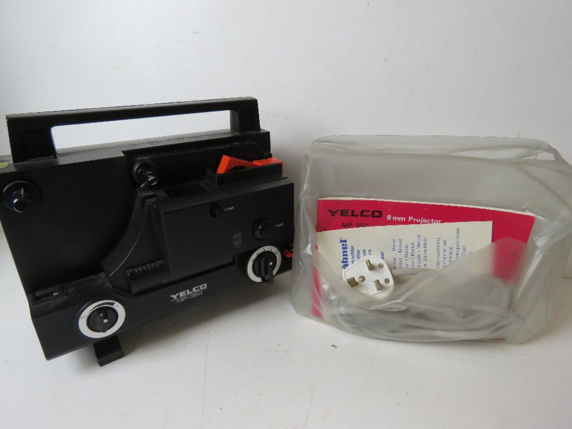 A Yelco MP-350 8mm projector with cable and booklet.