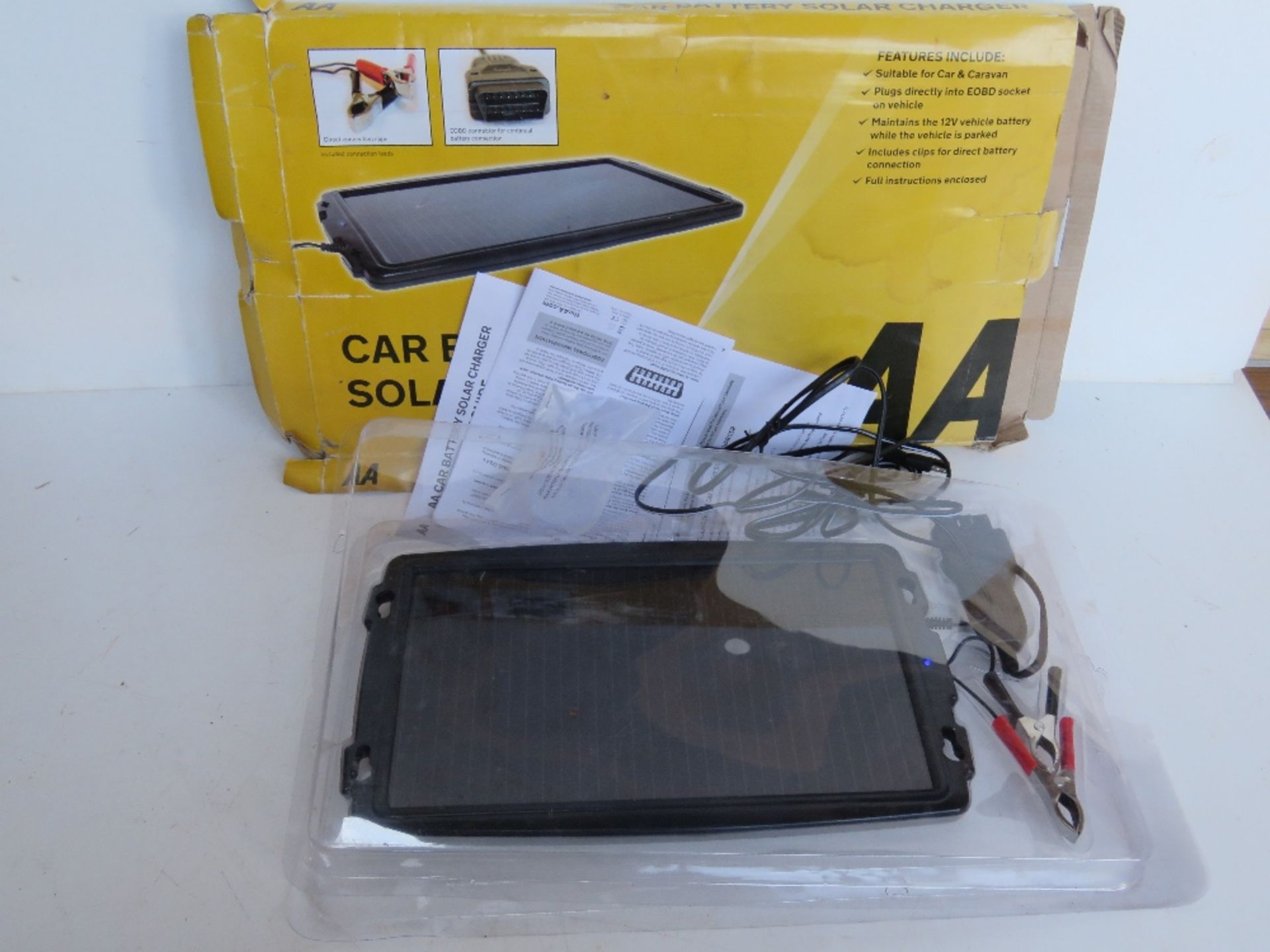 An AA car battery solar charger. In box, box a/f.