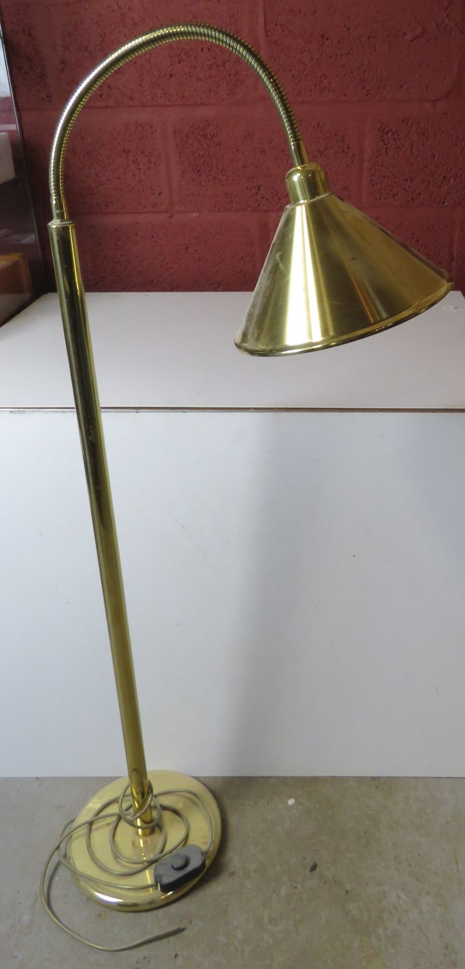 A brass floor standing lamp having articulated neck, for re-wiring.