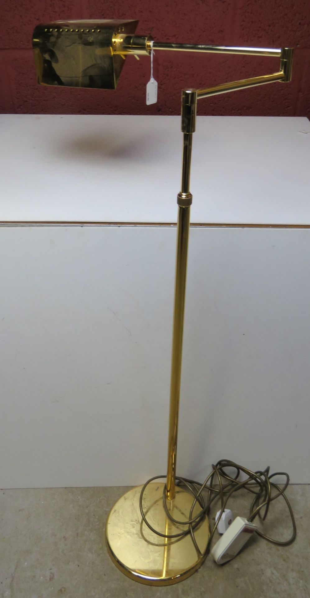 A mid century Italian made brass cantilever adjustable height floor lamp.