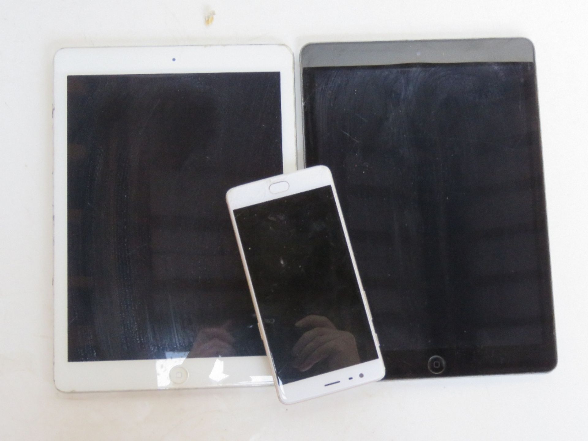 Two iPads and and iPhone, screens a/f.