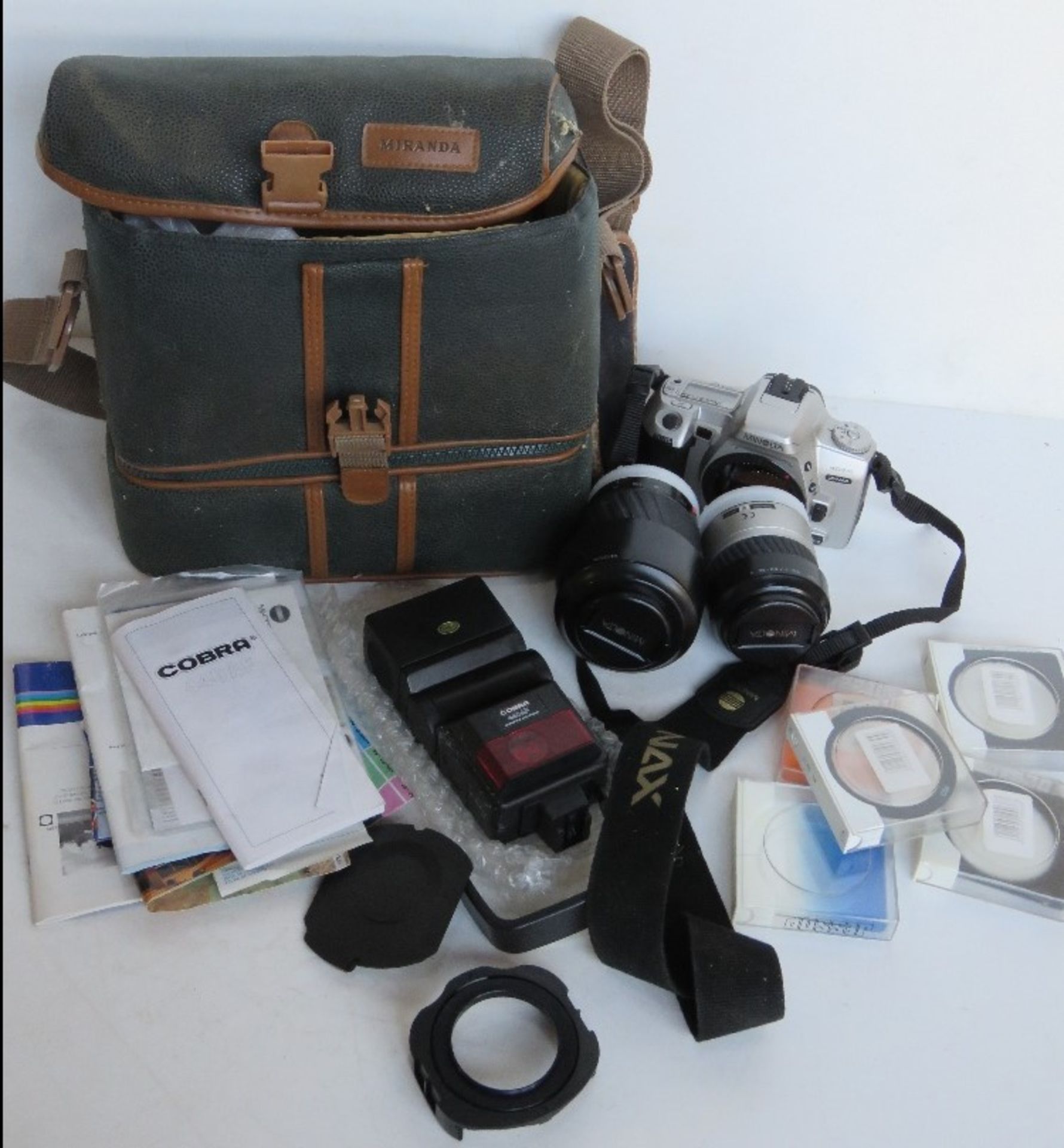 A Minolta 404SI camera with lenses, Cobra flash, etc.