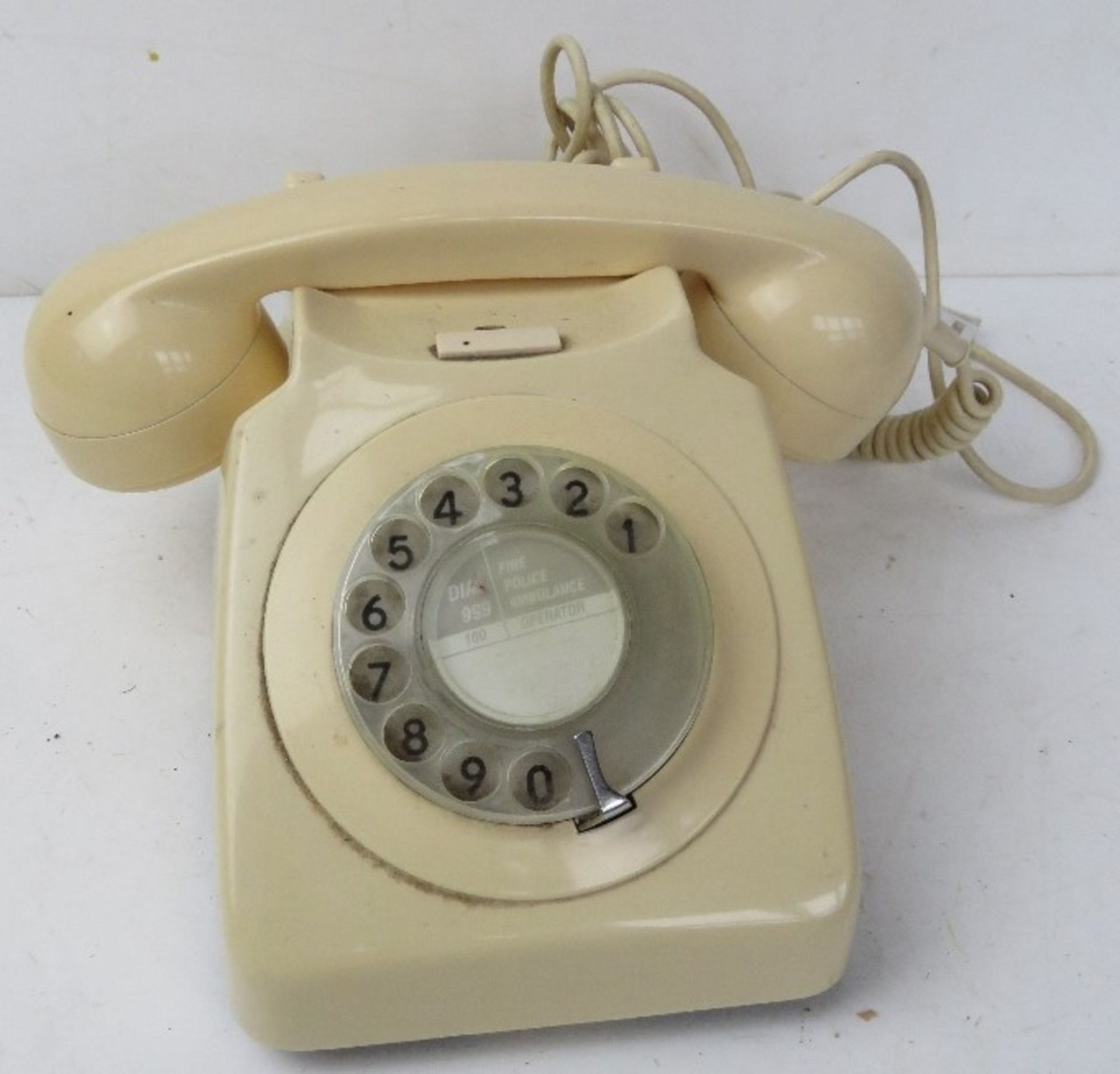 A contemporary cream coloured Rotary telephone.