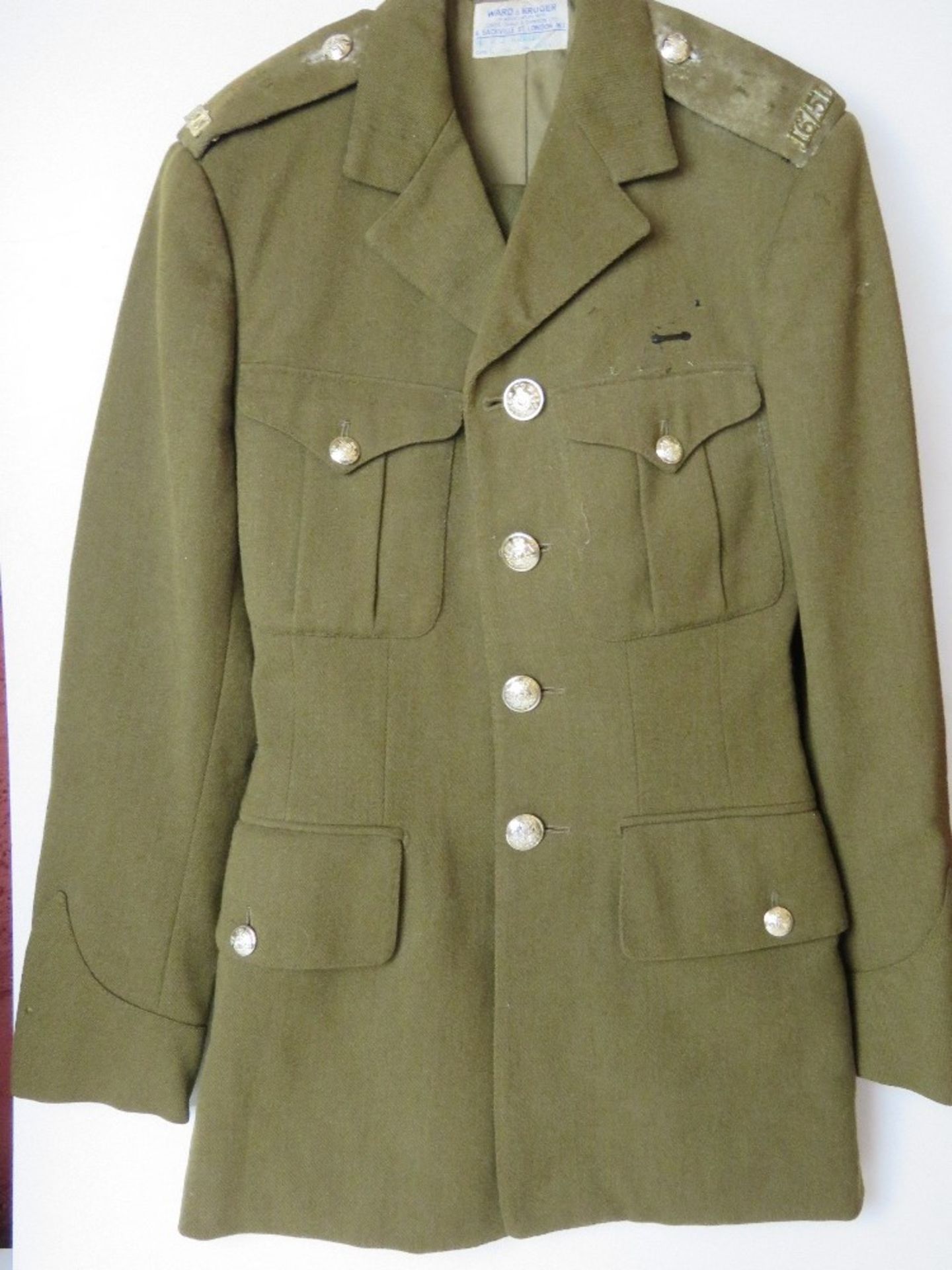 A British Army No 2 dress tunic and trousers, having epaulette badges upon,