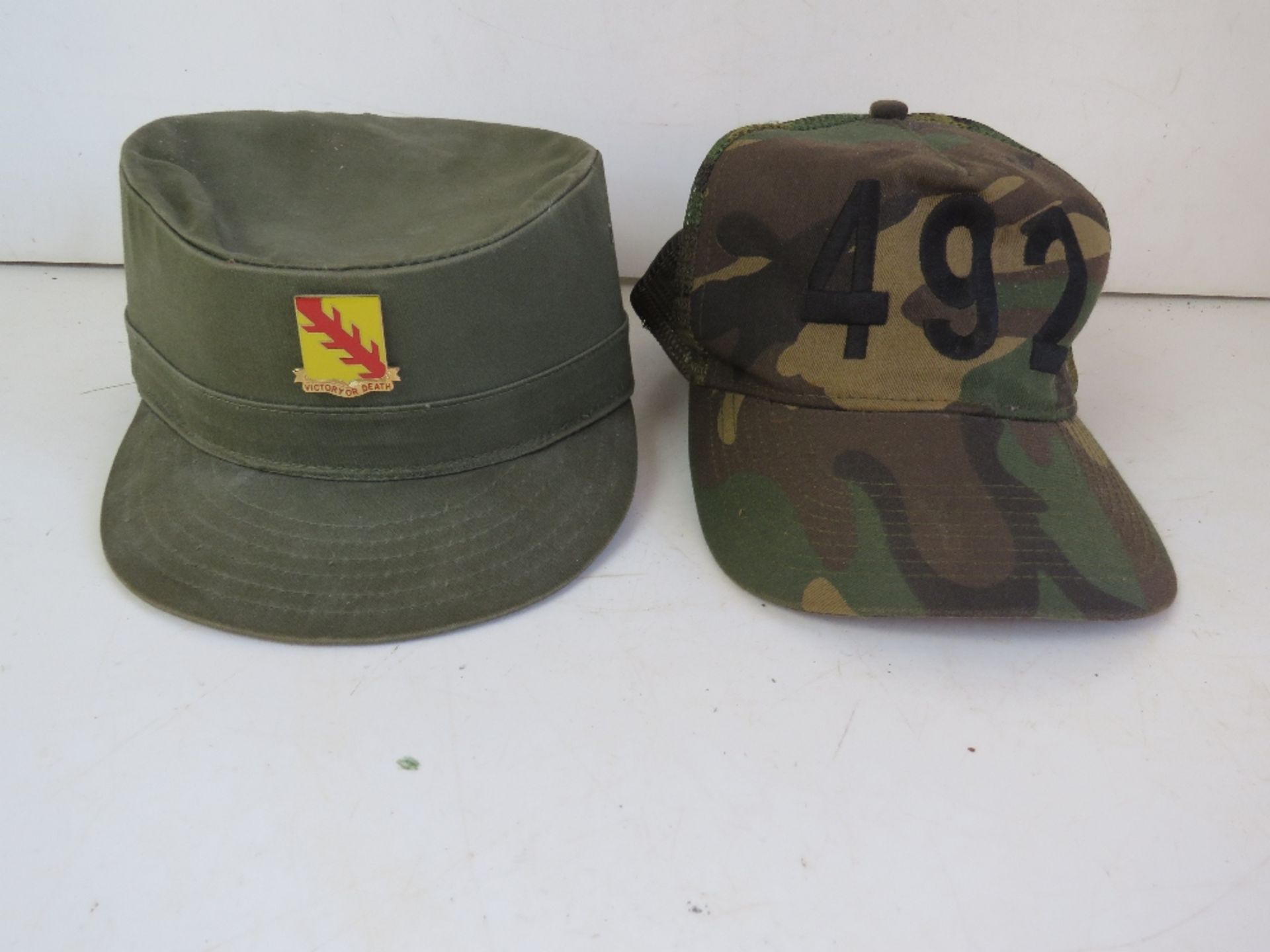 A US 32nd armoured cavalry regiment cap with badge size 7 1/8 and a 492 Otto camo cap.