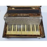 A Hess Klingenthl piano accordion in original case, mother of pearl effect key, 48.
