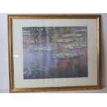 Print; Monet Waterlillies, framed and glazed in gold painted pine frame.