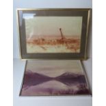 Two photographic prints, one of a lake with mountains beyond, the other of a giraffe,