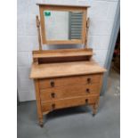 A stripped pine dressing table having three drawers and rectangular mirror over,
