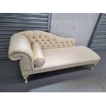 A smartly upholstered chaise longue in cream ground with cream painted cabriole legs,