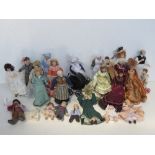 A quantity of soft body ceramic faced dolls house figures.