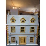 A 'Victorian Manor' dolls house with dining room, sitting room, nursery with child,