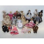 A quantity of soft body ceramic faced dolls house figures.